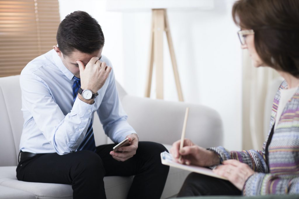 Depressed man at psychotherapy