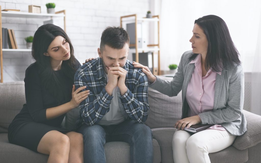 Depressed man feeling enclosed at psychological therapy session