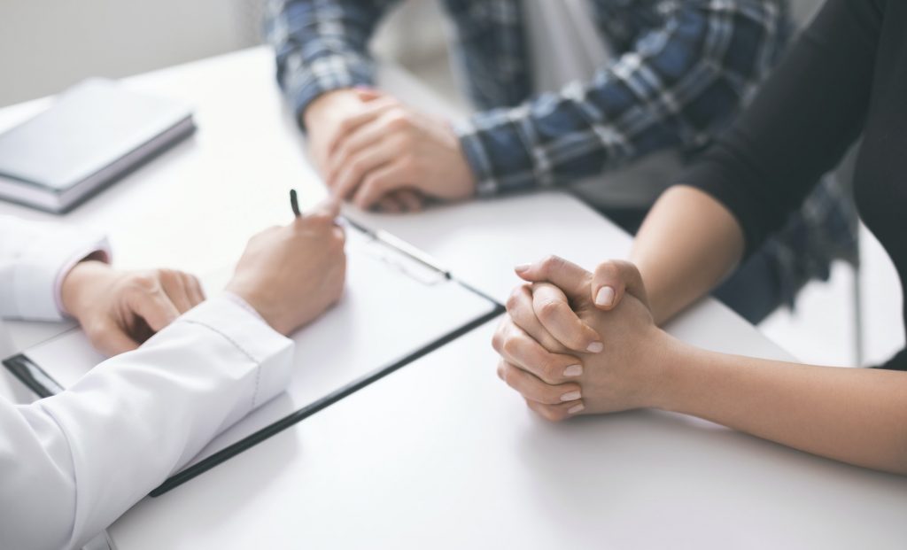 Doctor writing prescription and treatment plan to patients